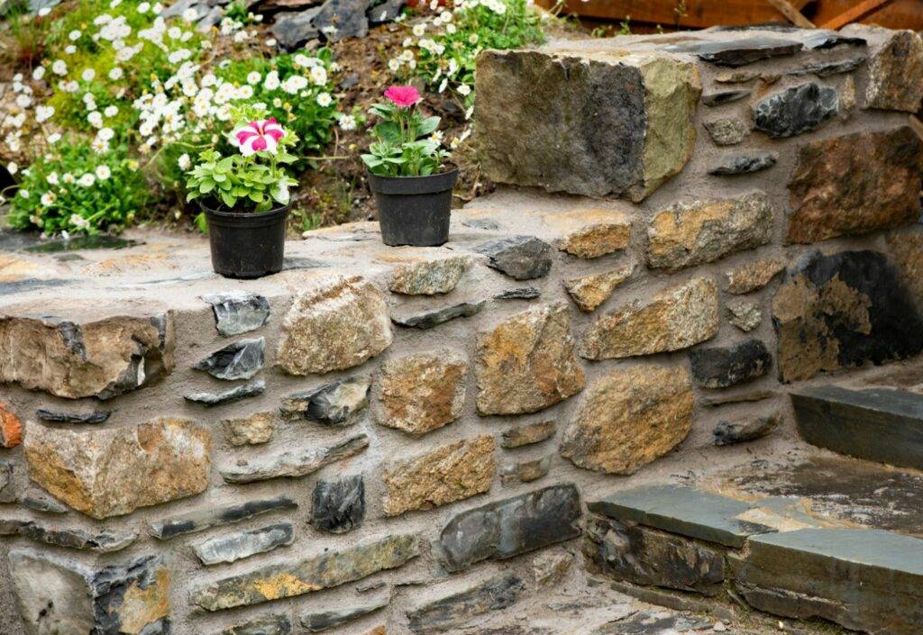 A picture of a garden with creative stone border designs