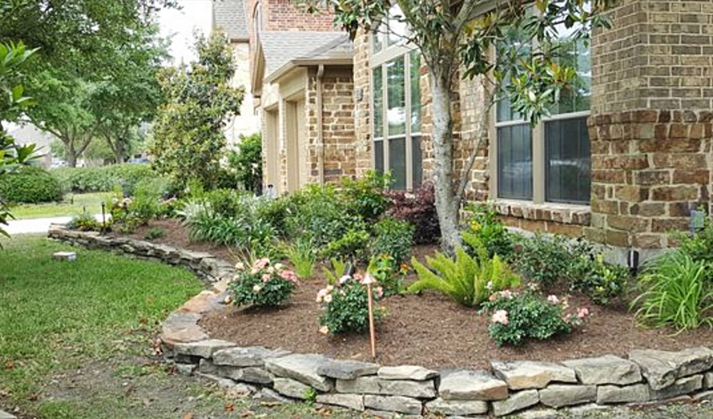 Classic area raised flowerbed edged with stacked stone